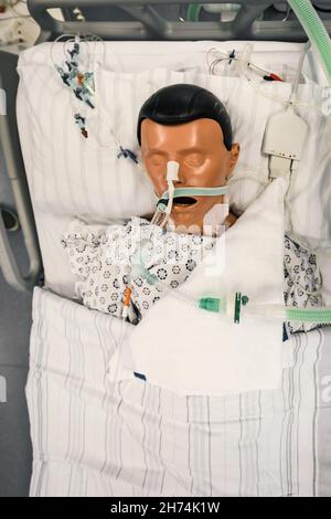 Patient dummy with intubation in hospital bed in intensive care unit of a hospital. Stock Photo