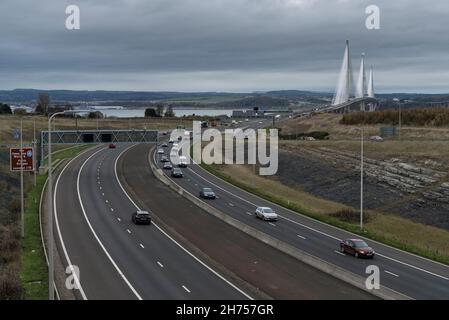 Moving traffic on M90 motorway in Scotland looking north towards the Queensferry Bridge across the River Forth estuary in daylight. Stock Photo