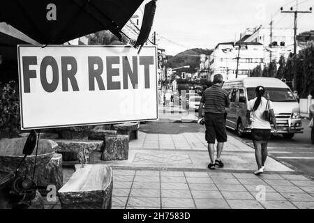 For Rent sign in the street, Thailand. Black and white urban photography, shallow DOF, focus on the signboard Stock Photo