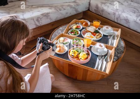 Young Female Photographer Make Photoshoot of Fresh Breakfast in Hotel Stock Photo