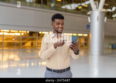 Portrait of young handsome African businessman wearing stylish clothes Stock Photo