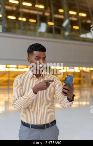 Portrait of young handsome African businessman wearing stylish clothes Stock Photo