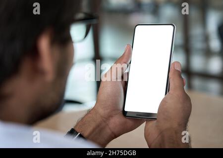 Business man holding phone in hand with white mockup screen template using app. Stock Photo
