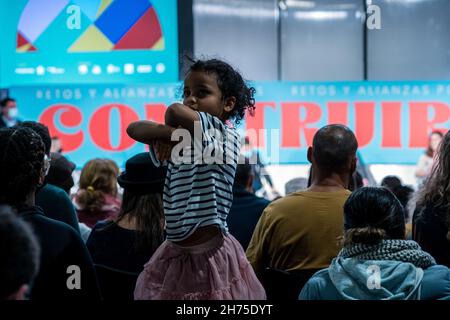 Madrid, Spain. 20th Nov, 2021. A girl plays during a political meeting.Spanish and Brazilian political and union leaders meet in Madrid to discuss the future challenges of left-wing parties and the need to build popular alliances at the international level to combat far-right movements. The forum was held at Casa America in Madrid. (Photo by Diego Radames/SOPA Images/Sipa USA) Credit: Sipa USA/Alamy Live News Stock Photo