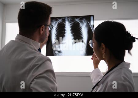 Two doctors studying a ribs x-ray image. Stock Photo