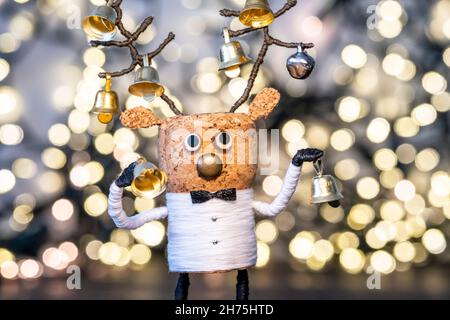 Creative Christmas Concept, Cork deer with Christmas bells and warm, welcoming Christmas lights Stock Photo