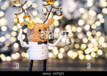 Elegant Cork deer with Christmas bells and bokeh background Gold Christmas home deco Creative Christmas Concept Festive cork Stock Photo