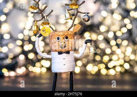 Creative Christmas Concept, festive cork, Cork deer with Christmas bells and warm, welcoming Christmas lights Stock Photo