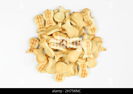 Pile of salty crackers isolated on white background. Fish shaped snack Stock Photo