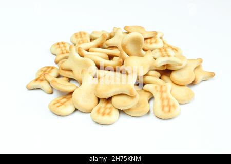 Pile of salty crackers isolated on white background. Fish shaped snack Stock Photo