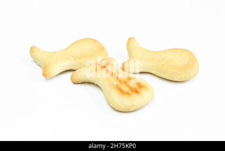 Few salty crackers isolated on white background. Fish shaped snack Stock Photo