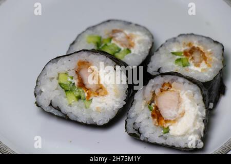 Japanese sushi food on plate. Maki rolls with tuna, chicken, avokado and cucumber Stock Photo
