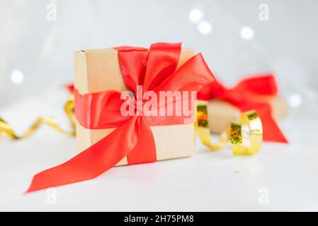 beautiful festive surprise gift box with a red bow on a bokeh background  for new year and valentine's day Stock Photo