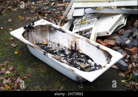 Old ceramic bath from demolition of derelict house on construction building site Stock Photo