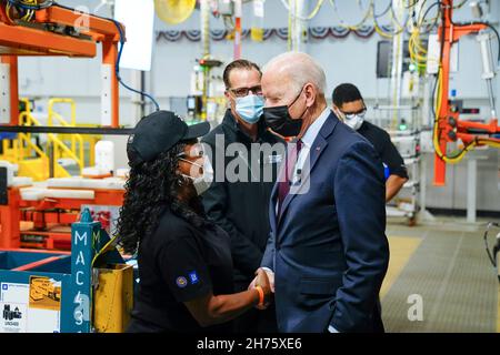 Detroit, United States Of America. 17th Nov, 2021. Detroit, United States of America. 17 November, 2021. U.S President Joe Biden greets a worker during a tour of the electric Hummer assembly line at the General Motors Factory ZERO electric vehicle plant, November 17, 2021 in Detroit, Michigan. Credit: Adam Schultz/White House Photo/Alamy Live News Stock Photo