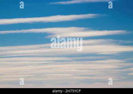 Background photo: blue sky and white clouds in the form of stripes. Blurred. High quality photo Stock Photo