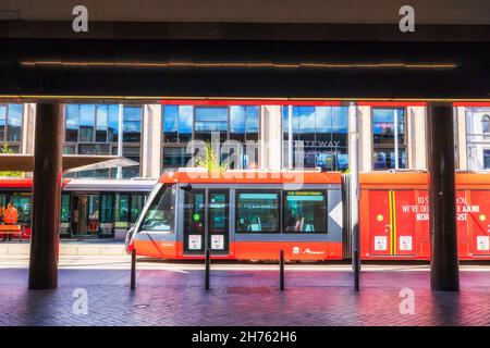 Sydney, Australia - 31 October 2021: Modern electric light-rail tram arriving at Circular quay tram stop in Sydney city CBD. Stock Photo
