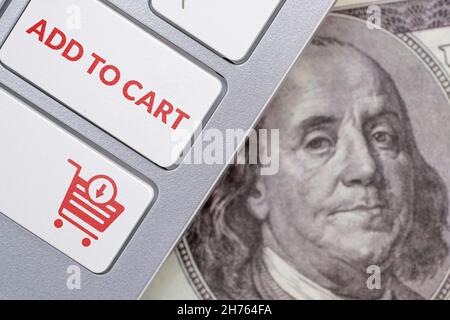 Concept add to cart. Online shopping symbol on the keyboard next to the us dollar bill Stock Photo