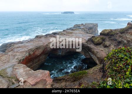 Devils punchbowl an arch with a circular opening Stock Photo