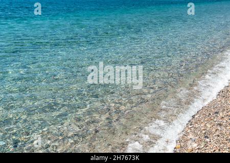 Pristine and calm Mediterranean sea water in a sunny day next to the shoreline in Sicily, Italy Stock Photo