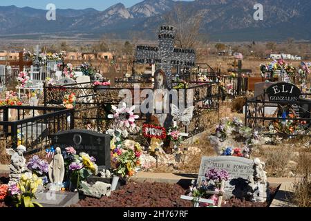 A woman visits a grave at the Jesus Nazareno Cemetery in Rancho de Taos ...