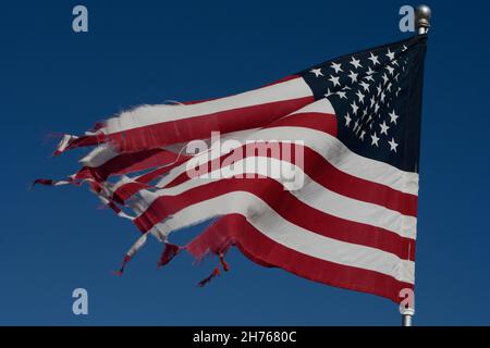 A battered American flag flies in a cemetery in Taos, New Mexico. Stock Photo