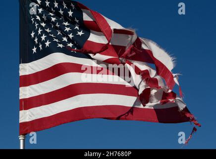 A battered American flag flies in a cemetery in Taos, New Mexico. Stock Photo