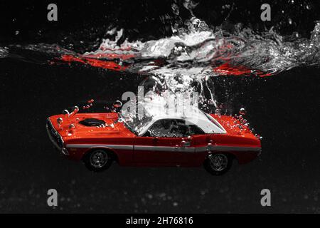 the car has fallen into the water creating large splashes and underwater bubbles Stock Photo