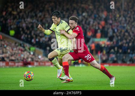 Liverpool. 21st Nov, 2021. Arsenal's Tomiyasu Takehiro (L) is challenged by Liverpool's Diogo Jota during the English Premier League match between Liverpool and Arsenal in Liverpool, Britain, on Nov. 20, 2021. Liverpool won 4-0. Credit: Xinhua/Alamy Live News Stock Photo