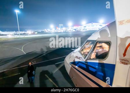 Night outside view of cockpit of a Belavia Boeing 737-800 plane before departure, airfield outdoor view, Minsk, Belarus Stock Photo