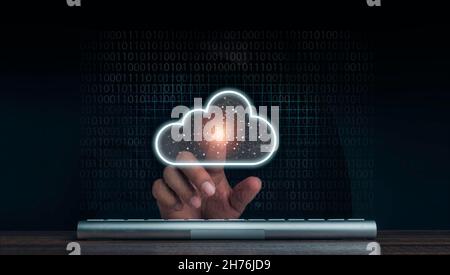 Cloud computing technology concept. Cloud icon virtual appeared while man pointing finger and keyboard computer with network and coding on dark backgr Stock Photo