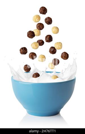 vanilla and chocolate corn balls falling in blue bowl Stock Photo
