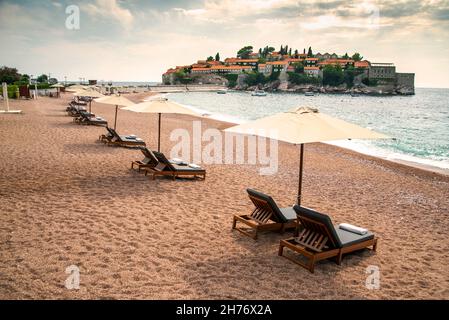 Aman Sveti Stefan Island juts out into the blue sea in the mid-September late summer,when the beautiful beaches are less crowded by peak season touris Stock Photo