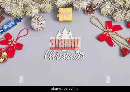 Flat lay. New Year. Noel. White Christmas gifts red ribbons, ornaments on blue background top view. Stock Photo