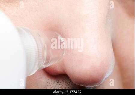 Cleaning skin pores on nose with tool macro close up view Stock Photo