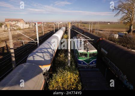 Buftea, Romania - 20 November, 2021: Freight train locomotive and oil wagons in a station. Stock Photo