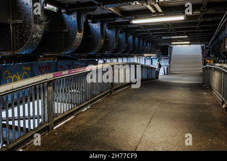 Grim pedestrian passage in railroad bridge over the Spree at Friedrichstrasse Station (1882) in Berlin, Germany. Stock Photo