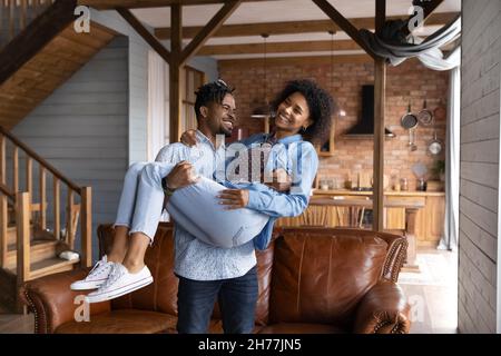 Happy young Brazilian man holding on hands joyful woman. Stock Photo