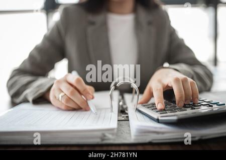 the businessman hands calculating invoice with calculator. Stock Photo