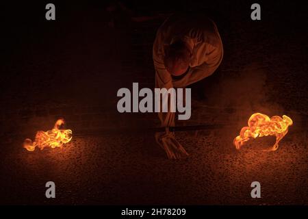 Fire performance by a street artist unknown at night with burning torches in the Tellaro village for the festival of the fairy village Stock Photo