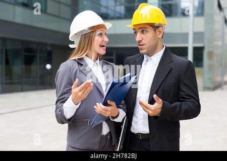 Portrait of smiling architectors who standing with folder Stock Photo