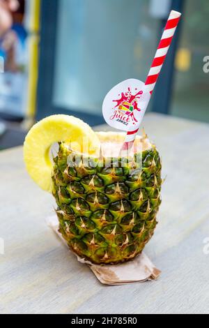 Fresh fruit juice served in a pineapple skin from Juice Junkiez at Buck Street Market Camden London UK Stock Photo Alamy