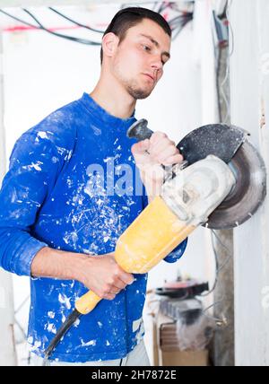 Male contractor using angle grinder Stock Photo