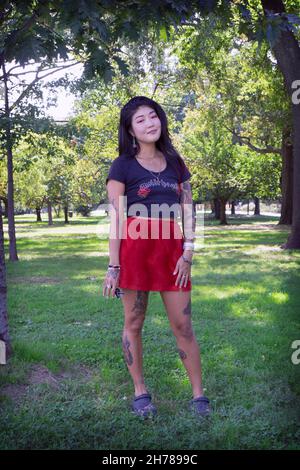 An attractive woman with multiple tattoos and her own individual look. In Flushing Meadows Corona park in Queens, new York Stock Photo