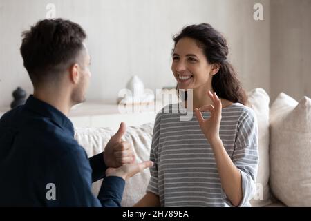 Latina woman communicates with man using sign language Stock Photo