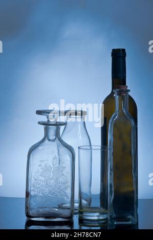 Still life of glass bottles in blue light Stock Photo