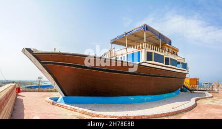 abandoned brown fishing boat on the ground in chabahar, a boat places on the ground for show, baluchistan province iran Stock Photo