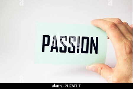Passion words on a note in a man's hand on a light background Stock Photo