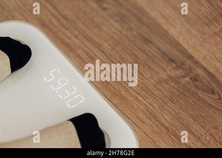 Girl Measures Weight on Smart Scales. Modern Electronic Device. Stock Photo
