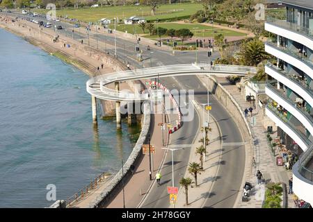 Spiral footbridge across the seafront road at Torquay, South Devon. Stock Photo